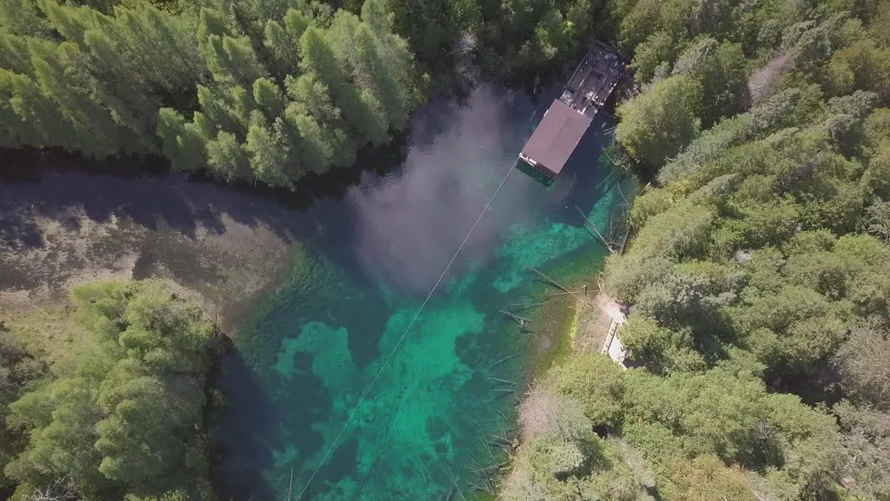 Aerial drone shot over crystal blue water of Kitch-iti-kipi the big spring in Palms Book State Park Michigan