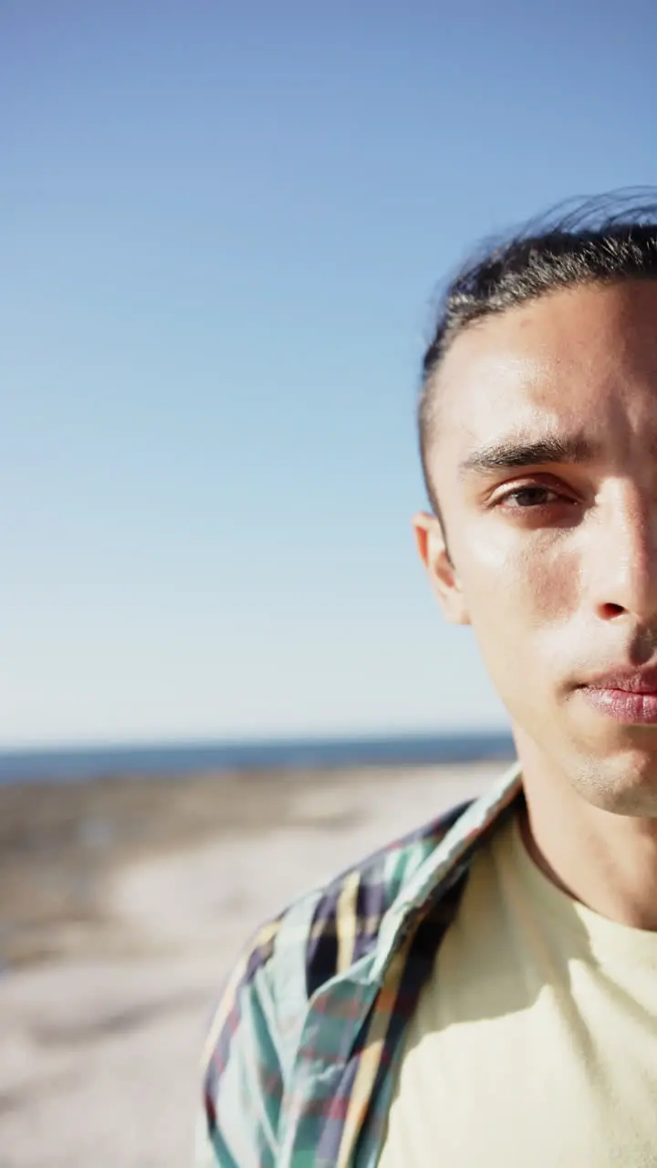 Vertical video of happy biracial man at promenade by the sea slow motion