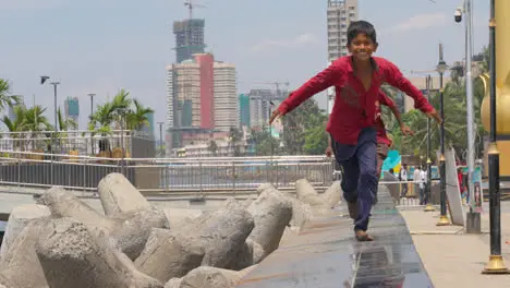 Children Running Towards Camera Along Wall On Dadar Beach Mumbai India