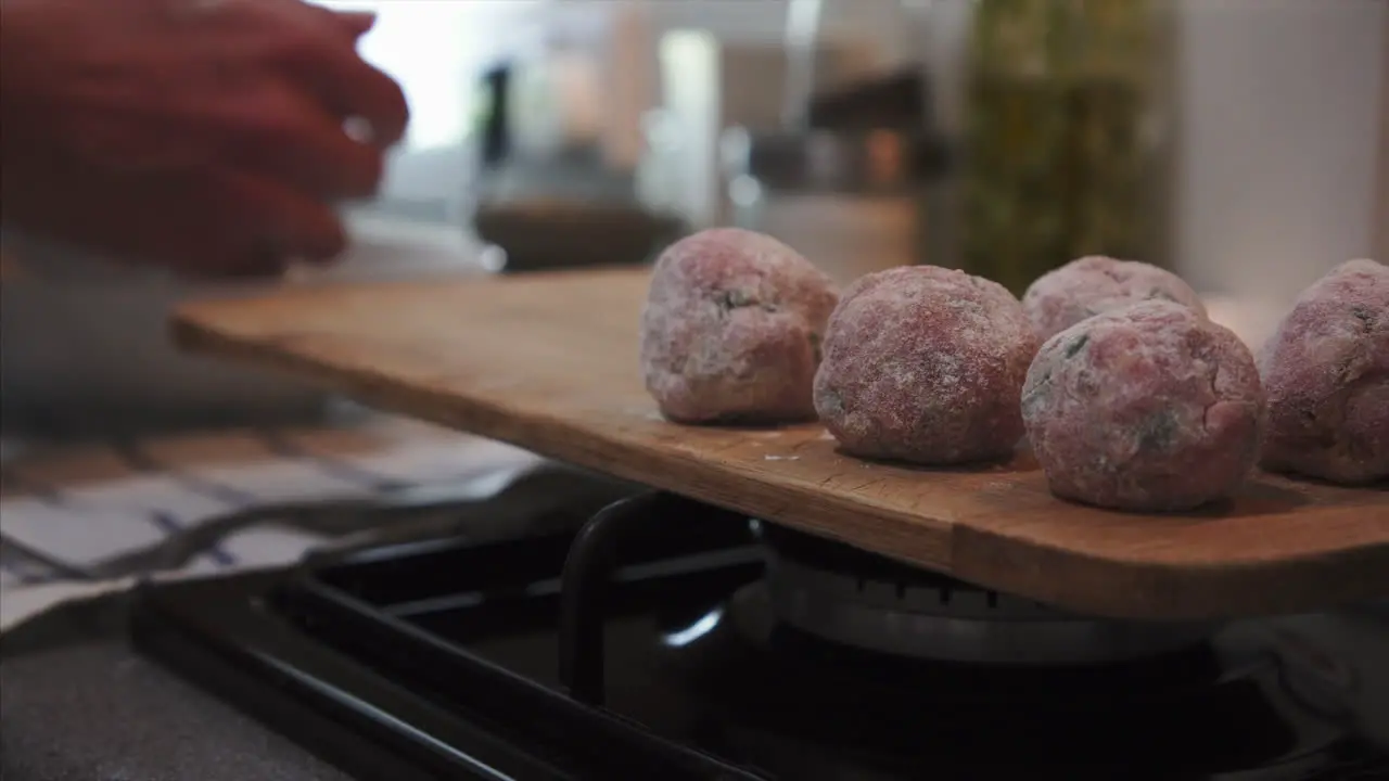 Housewife preparing delicious beef meatballs on kitchen counter top