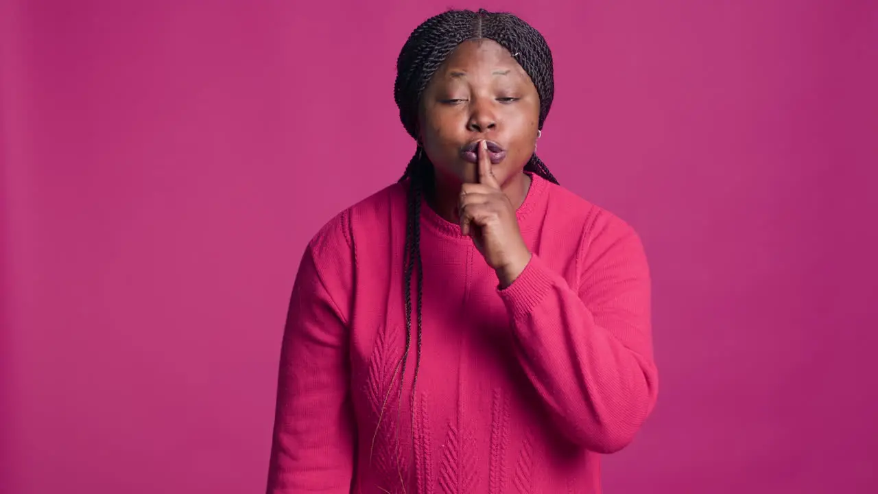 Woman Saying Quiet With Finger On Mouth