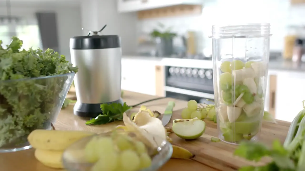 Vegetables and fruits with kitchen equipment on countertop in kitchen at home slow motion