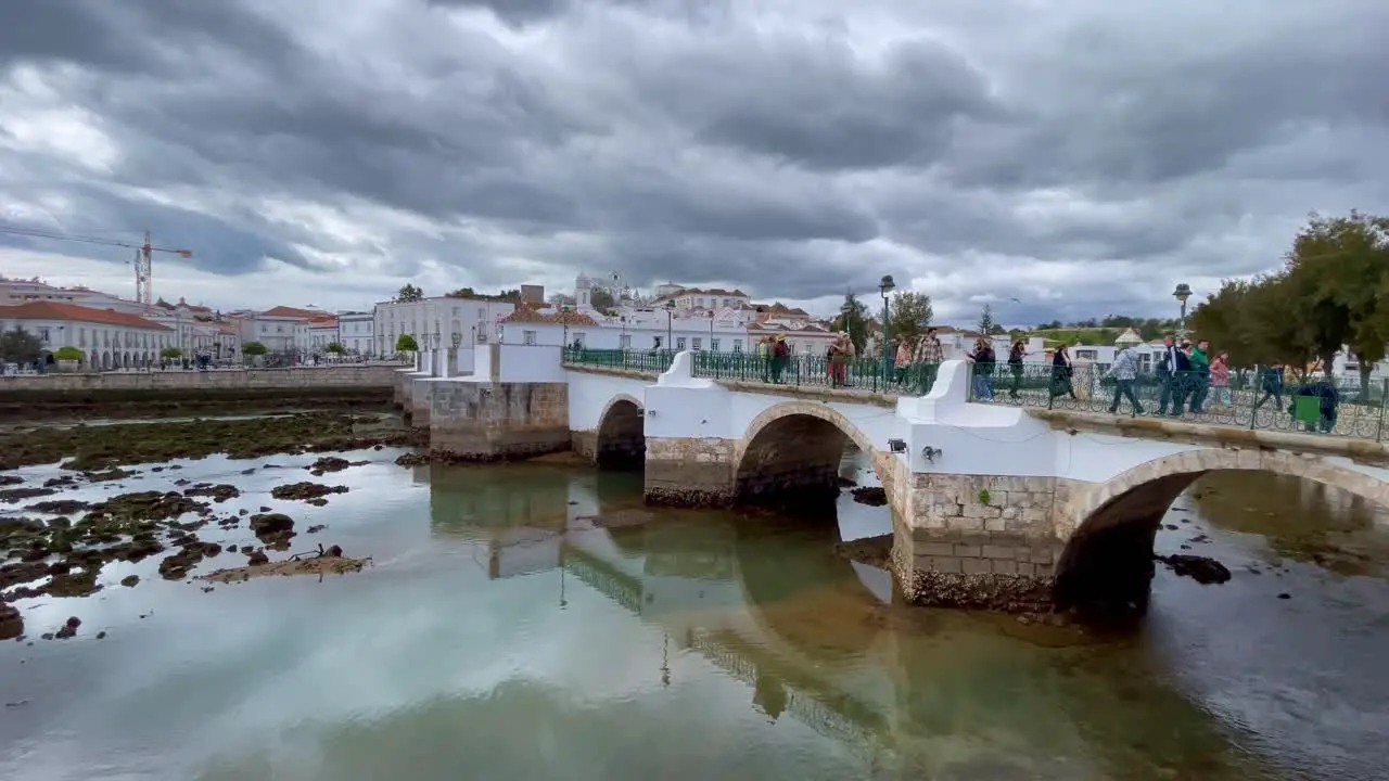 Rain clouds approach the Ponte Romana Bridge Tavira Portugal