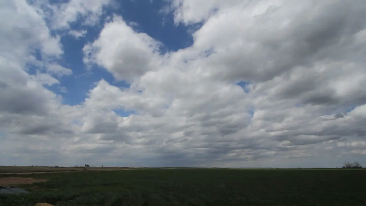 Slow time lapse of moving clouds over plains