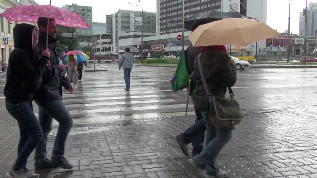 Tallinn Estonia on a rainy day with green bus and umbrellas