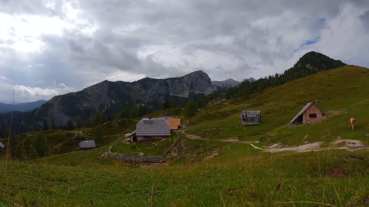 Timelapse filmed on top of a mountain called Krstenica in the Slovenian mountains in the alps with surrounding houses mountains and animals