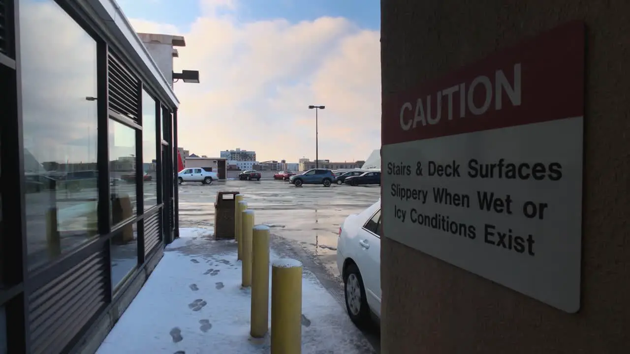 City Parking Garage Roof In The Snow With Caution Warning Sign