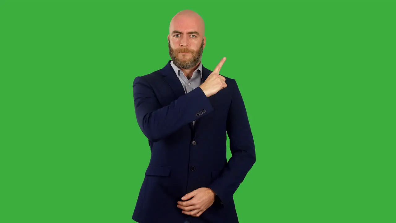 A businessman pointing to the corner with his finger