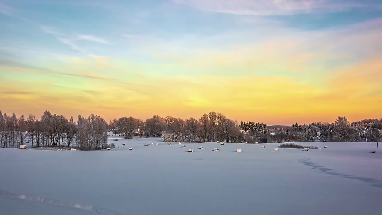 Time lapse flowing clouds over in winter Snow-covered tree foreground