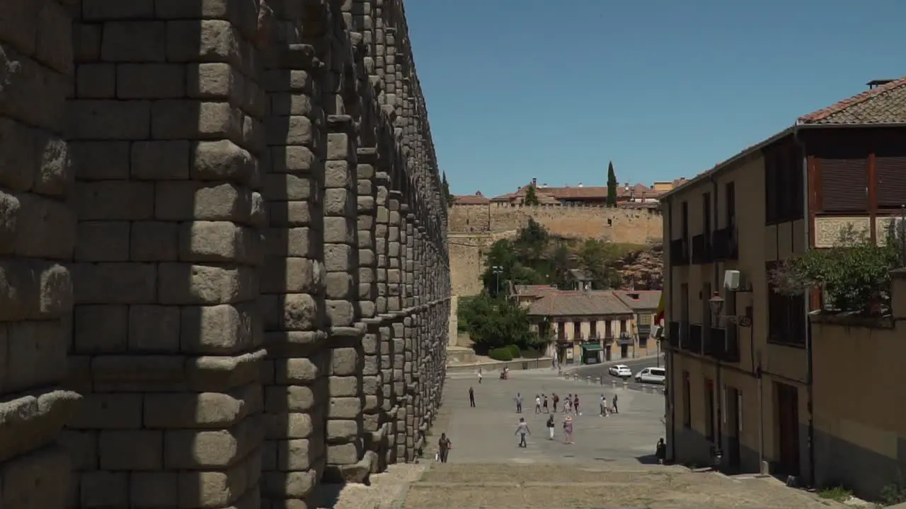 POV view walking down steps next to ancient aqueduct watercourse in Segovia Spain near Madrid SLOW MOTION