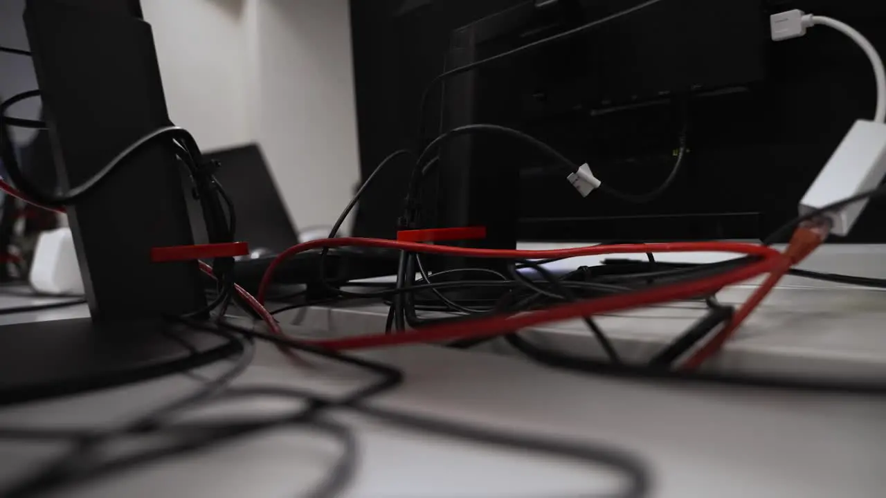 Close Up Behind Computer Monitor Stand Of Cables Ethernet Power Leads