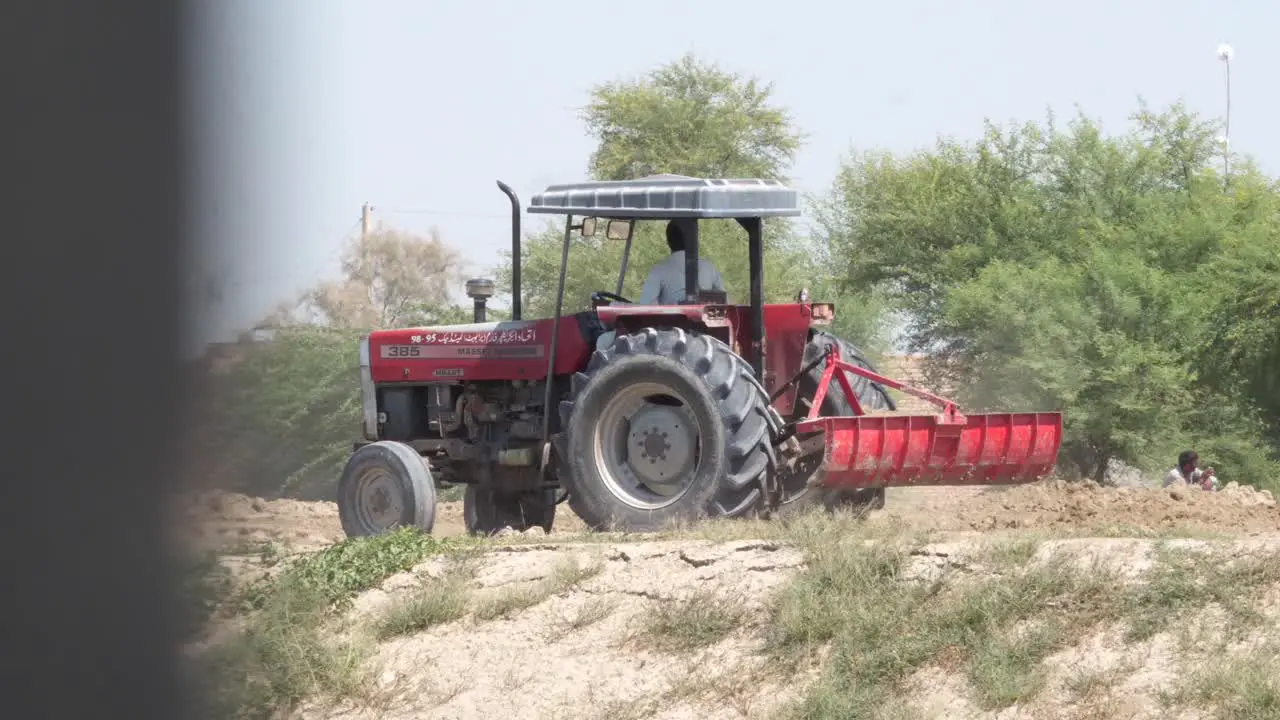 Red Tractor Reversing On Land In Punjab Pakistan