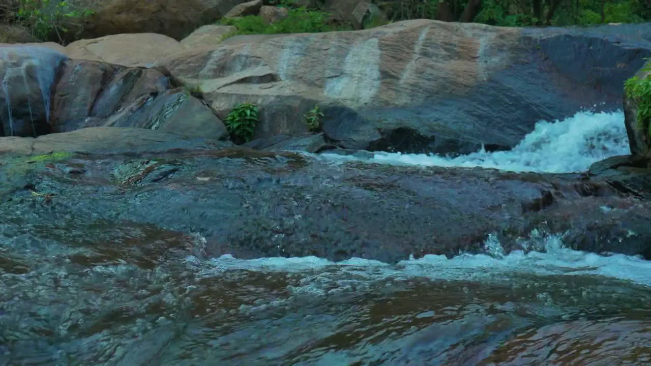 Slow motion of waterfall flowing down some rocks