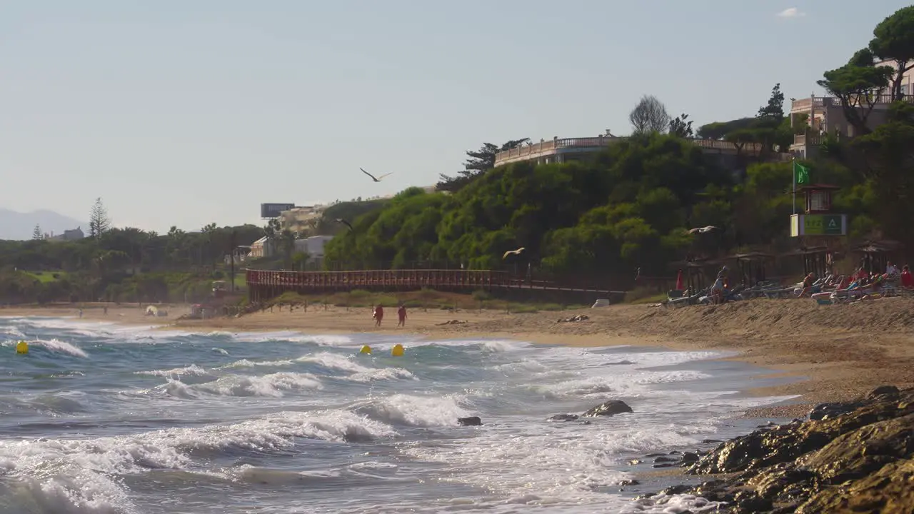 Static shot of Andalusia coastline in slow motion with seagulls flying by