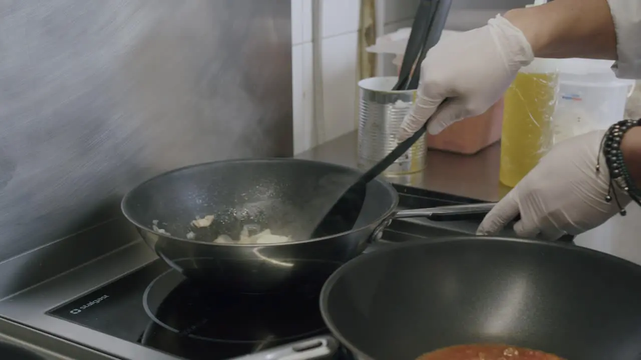 A professional Italian chef is cooking a typical sauce for pasta