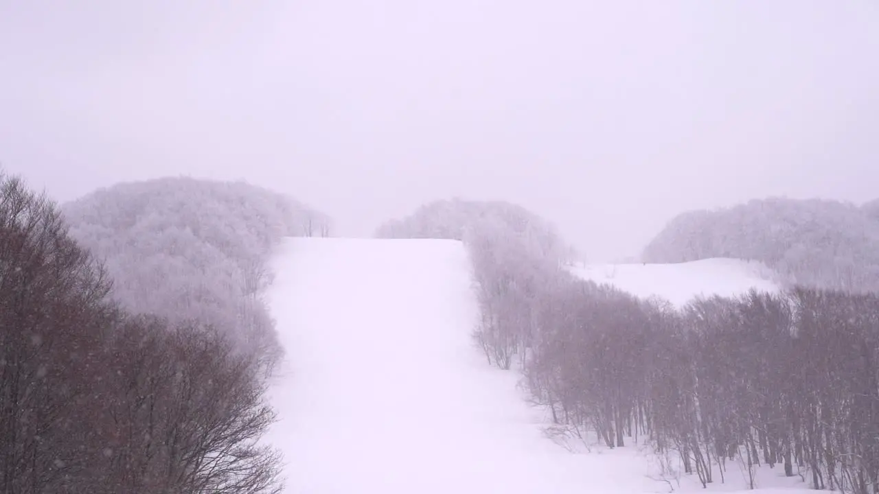 Slow motion snowy skiing slopes in forest with no people