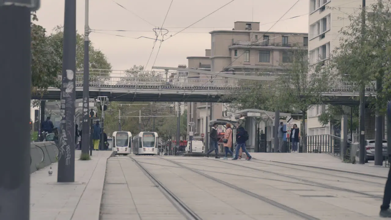 Slow Motion Shot of a Man Crossing Tramway Rails In Vincennes France