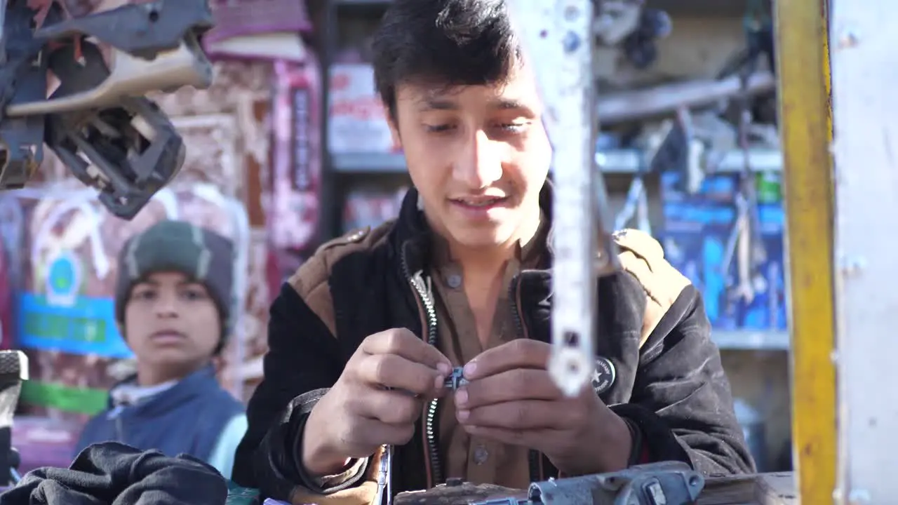 Young Male At Outdoor Shop Stall With Hanging Car Parts Fixing Part In Quetta