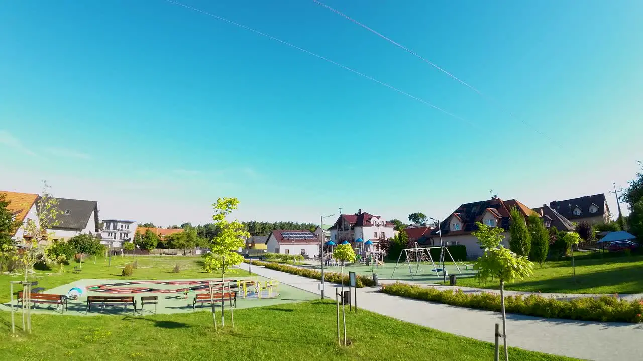 FPV Drone Flying Over Urban Grass Towards Playground