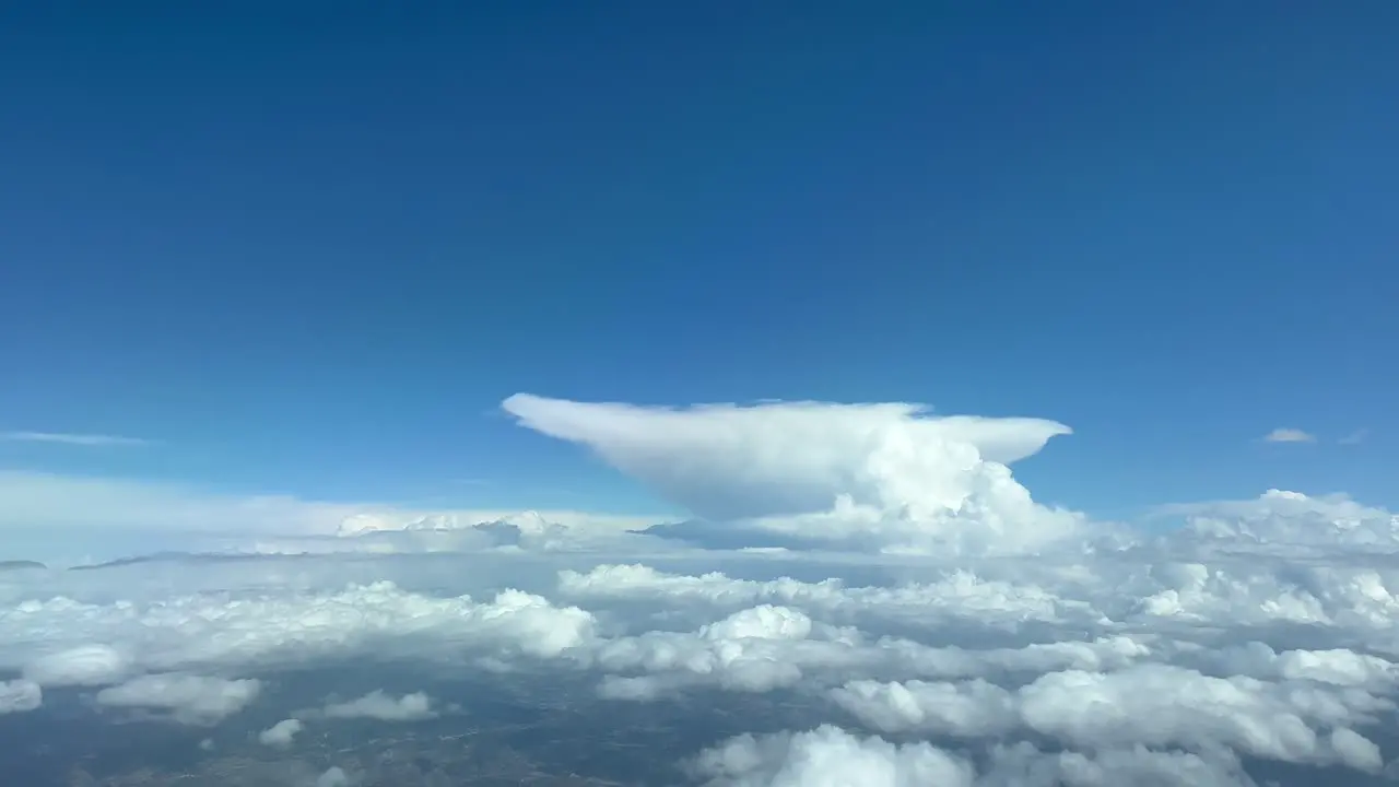 Unique view of the top view of a huge cumulonimbus anvil shape from a jet cockpit flying at 12000 metres high