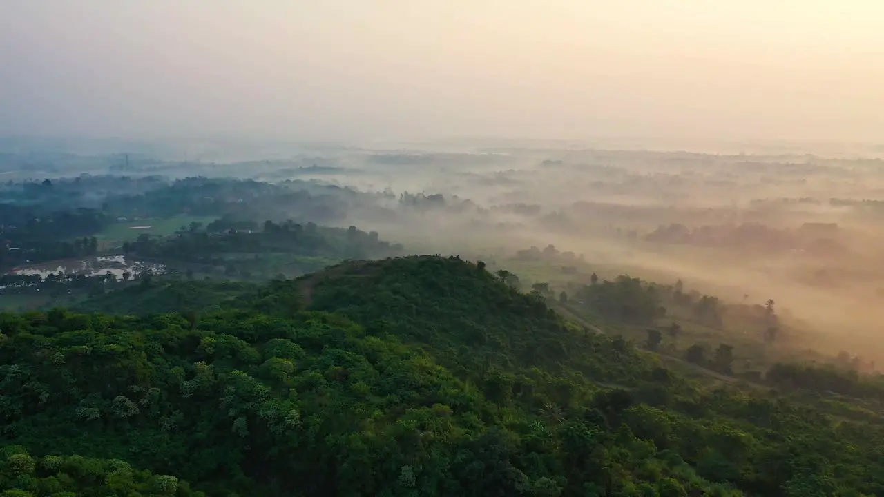 Aerial foggy and misty hilly landscape drone scenic view of a nature park with a white mantle and copy space