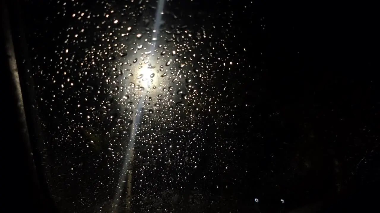 Car glass in raindrops