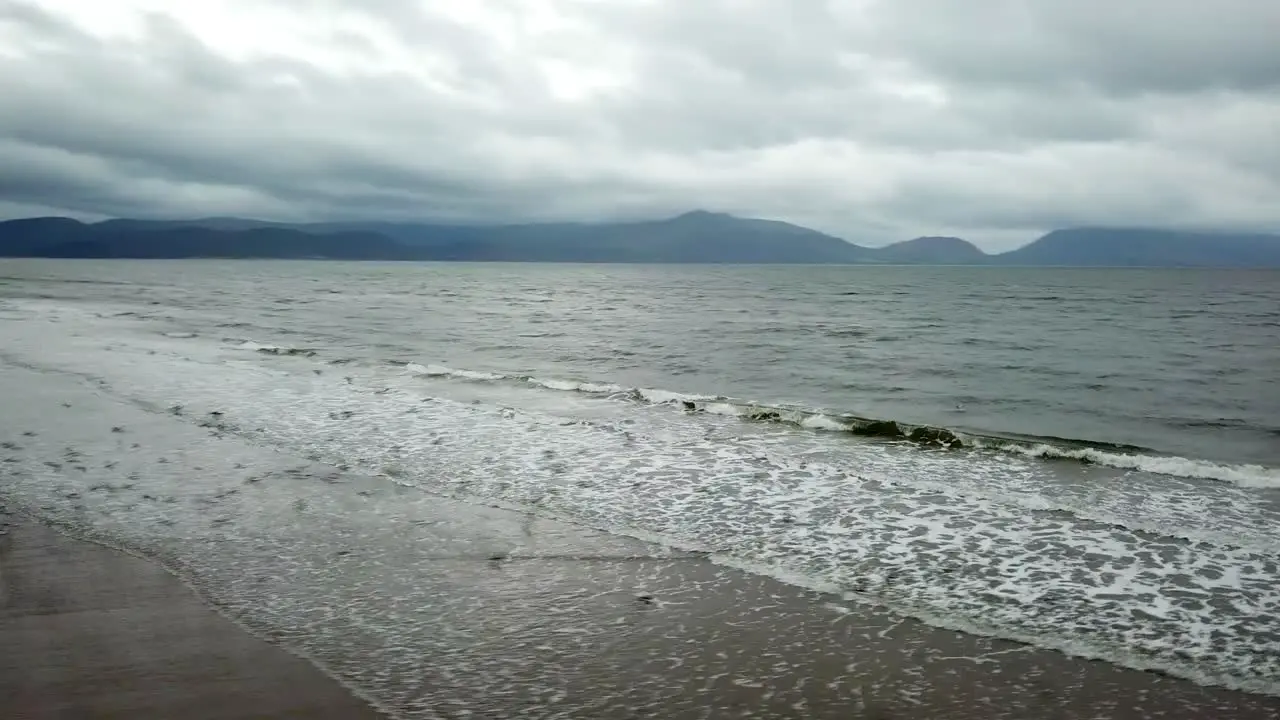 Birds fly over ocean waves in ireland