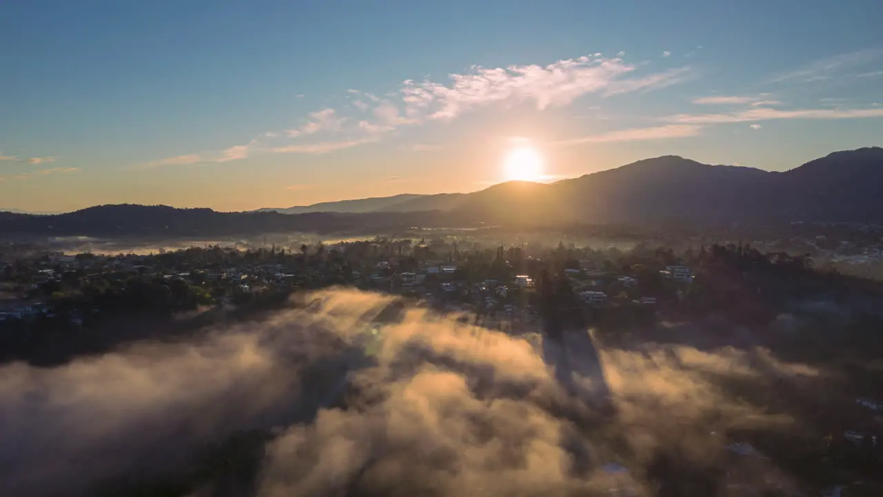 Sun rising over the mountains with fog stunning aerial view in the caribbean morning view in a tropical country