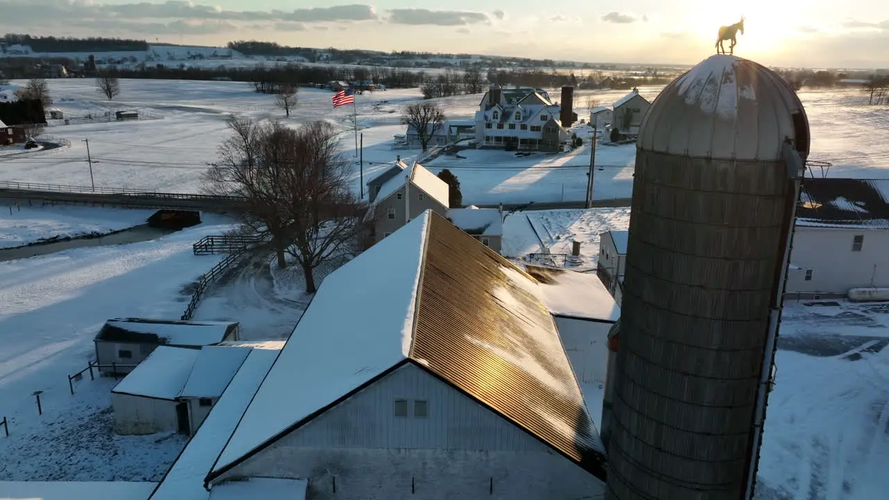 Family farm in winter sunset