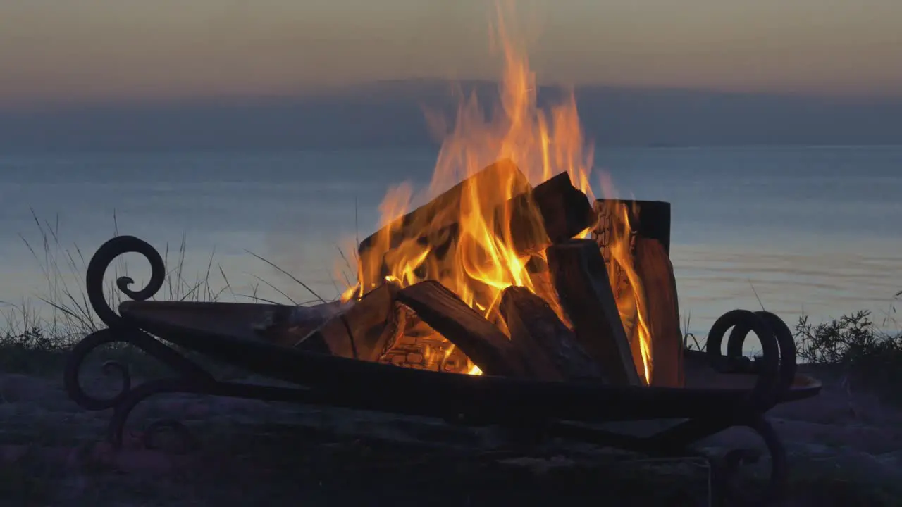 A burning bonfire on a Latvian seaside beach at sunset