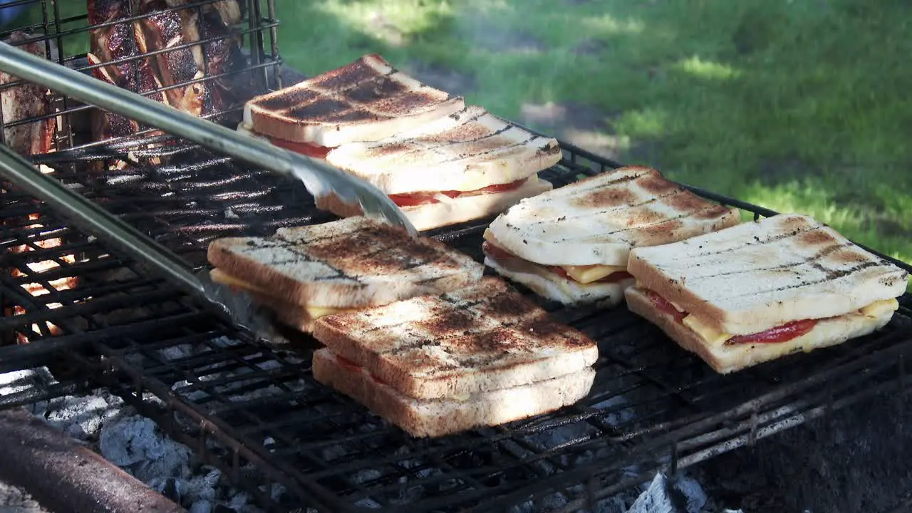 Cheese tomato and onion sandwiches grilling on a barbecue in South Africa