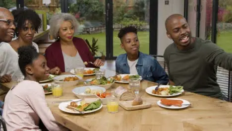 Family Taking Selfie Together During Family Dinner 