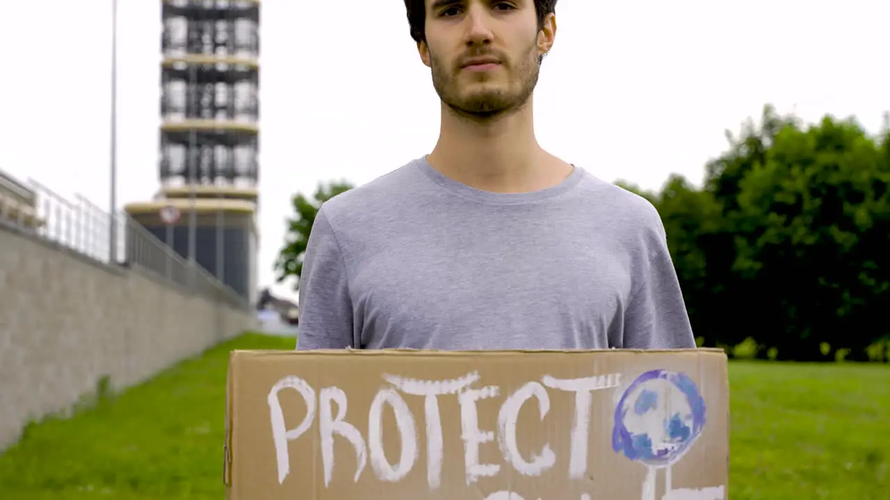 Close Up Of A Handsome Man Holding A Placard