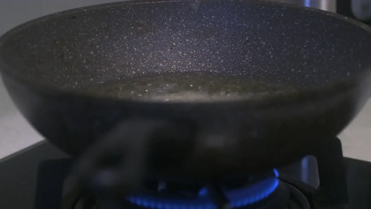 View of person putting chicken Nuggets into Wok to cook