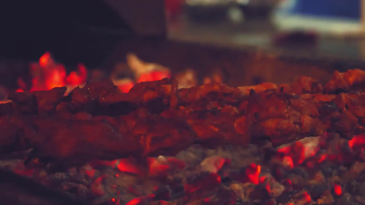 Shish Kebab On Metal Skewers Being Placed On Hot Red Coal Tray