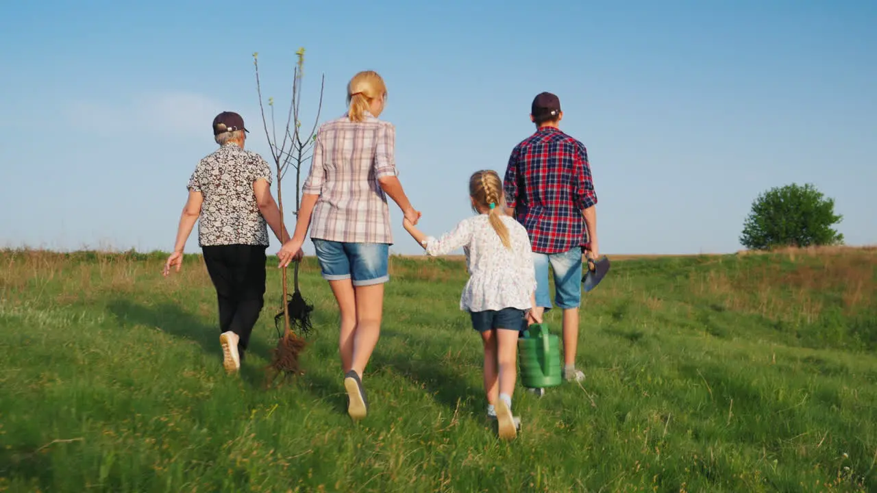 A Friendly Family Is Going To Plant Trees One After Another