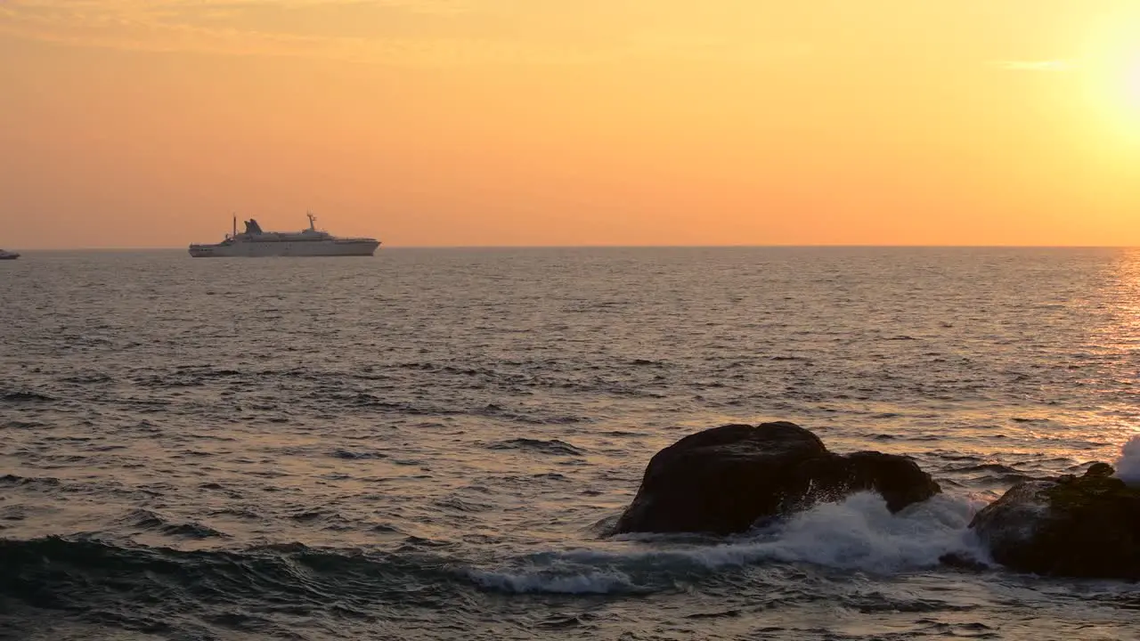 Steady silhouetted Sailboat in the horizon beautiful sunset landscape view in the beach in Galle fort