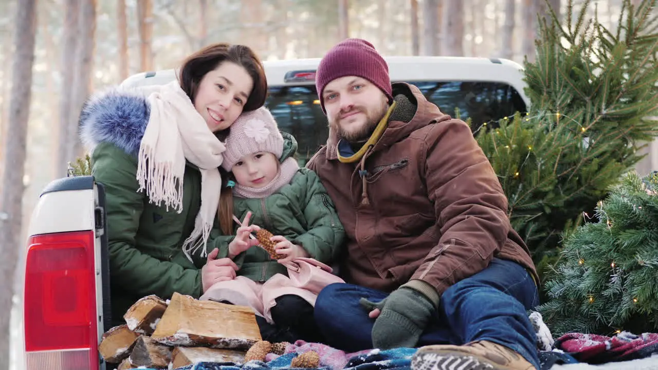 A Happy Young Family Getting Ready For The Christmas Morning Sitting In The Back Of The Car After A 