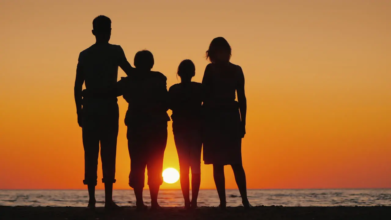 Happy Multi-Generational Family Enjoying Sunset Over The Sea