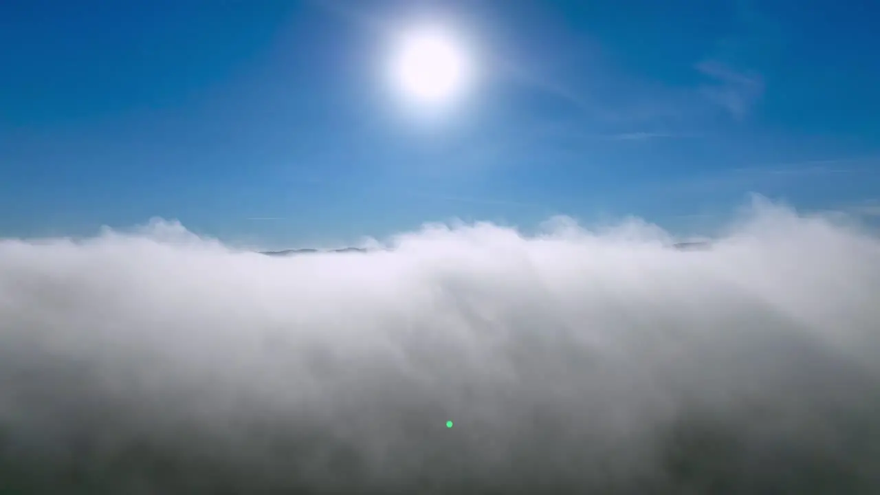 AERIAL PUSH THROUGH CLOUDS TOWARD THE SUN TO REVEAL THE BRUSHY MOUNTAINS NEAR WILKESBORO NC NORTH CAROLINA