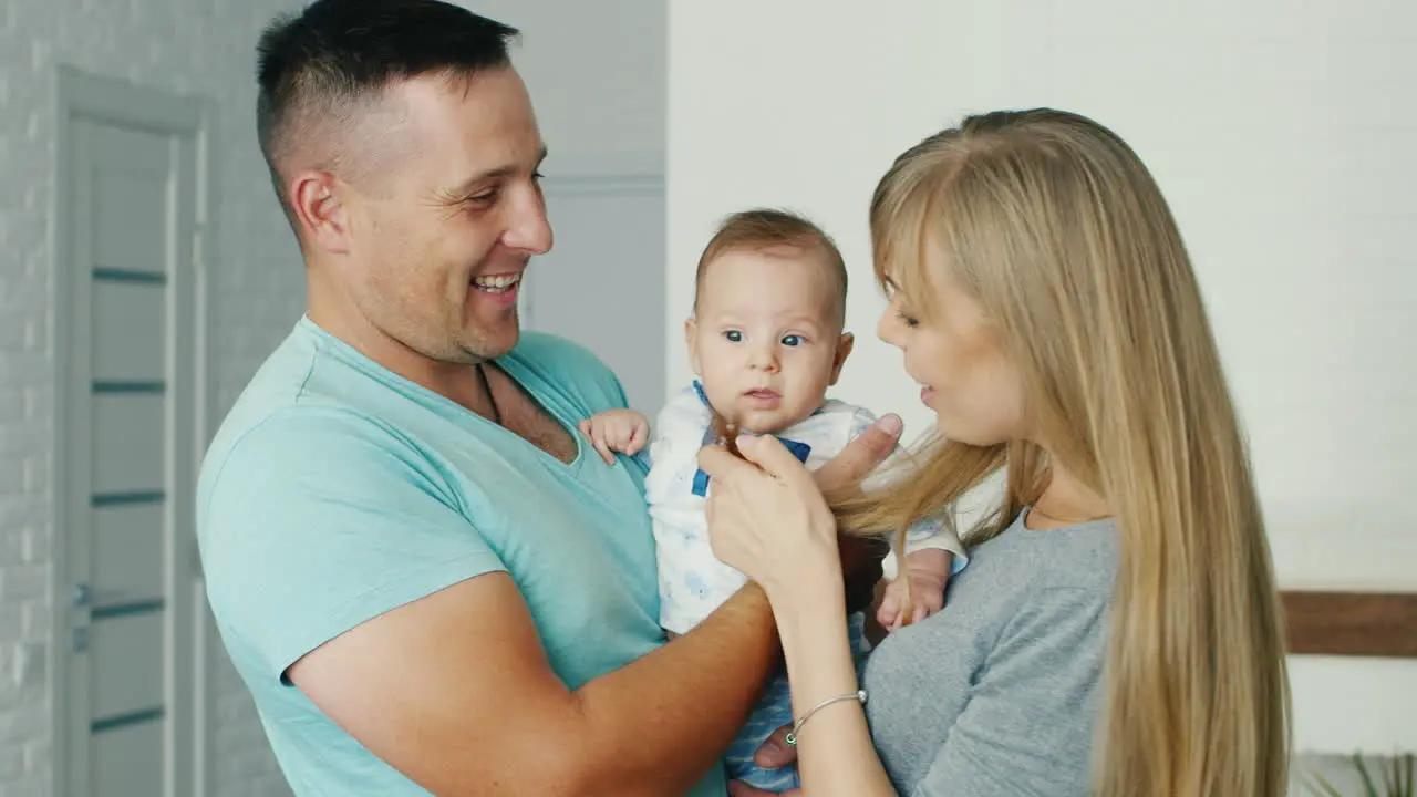 Young Parents Playing With His Son Two Months Happy Family And Home Comfort