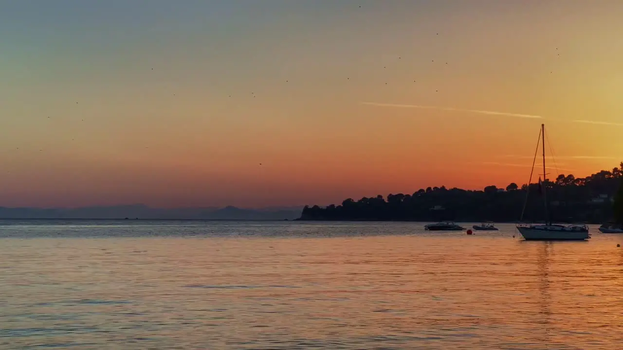 Slow Panning Handheld View Of Golden Sunset Reflecting