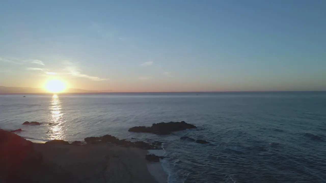 Slow upward view of sunrise at an empty beach