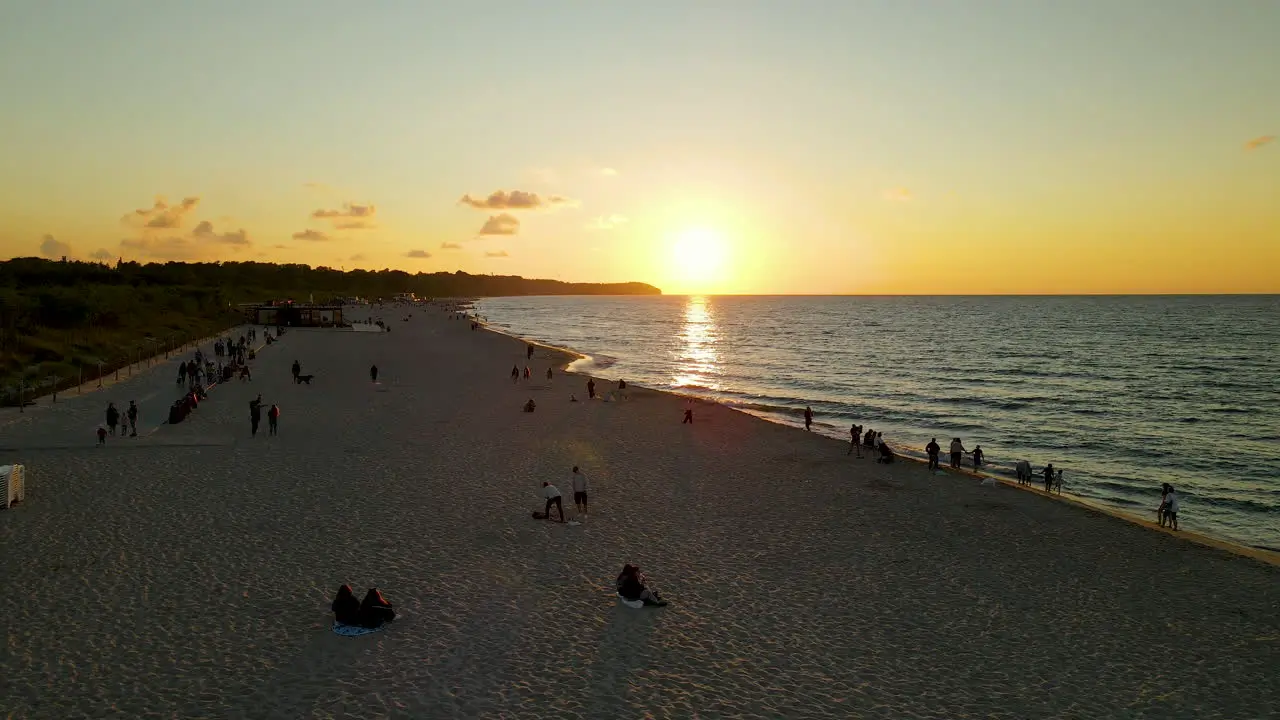 People enjoying sunset on coast of Baltic Sea in Poland aerial