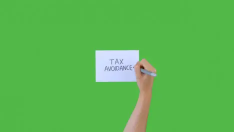 Woman Writing Tax Avoidance on Paper with Green Screen 02