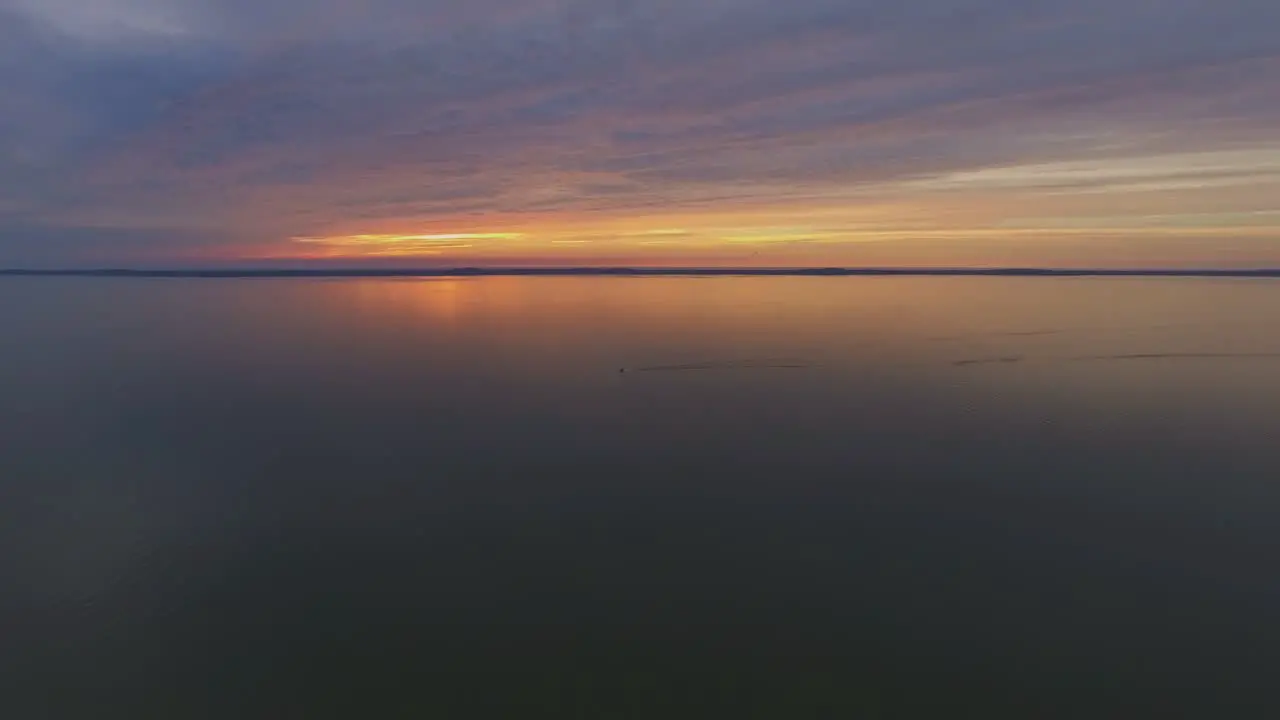 Yacht Far in the Curonian Lagoon at Sunset