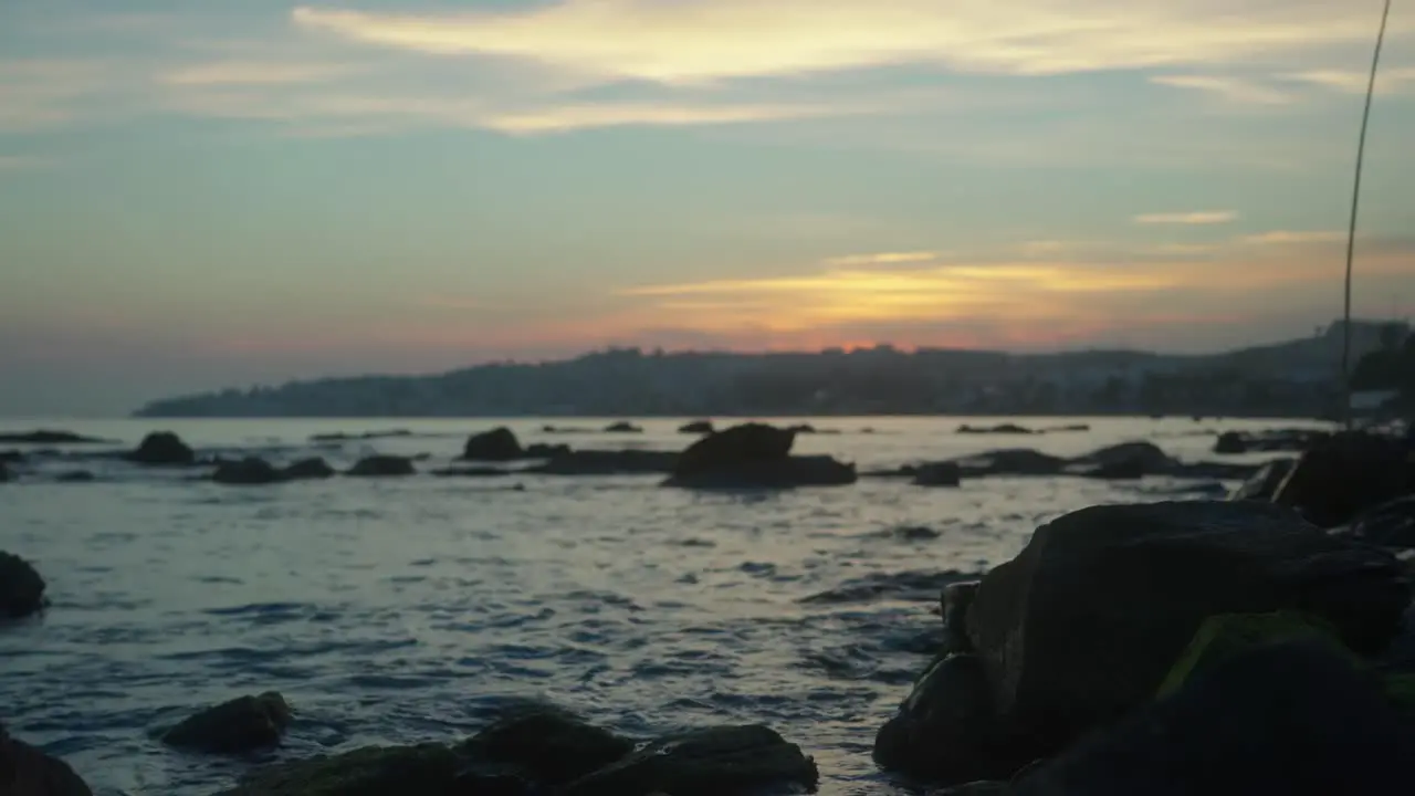 Defocused background at a rocky beach during twilight