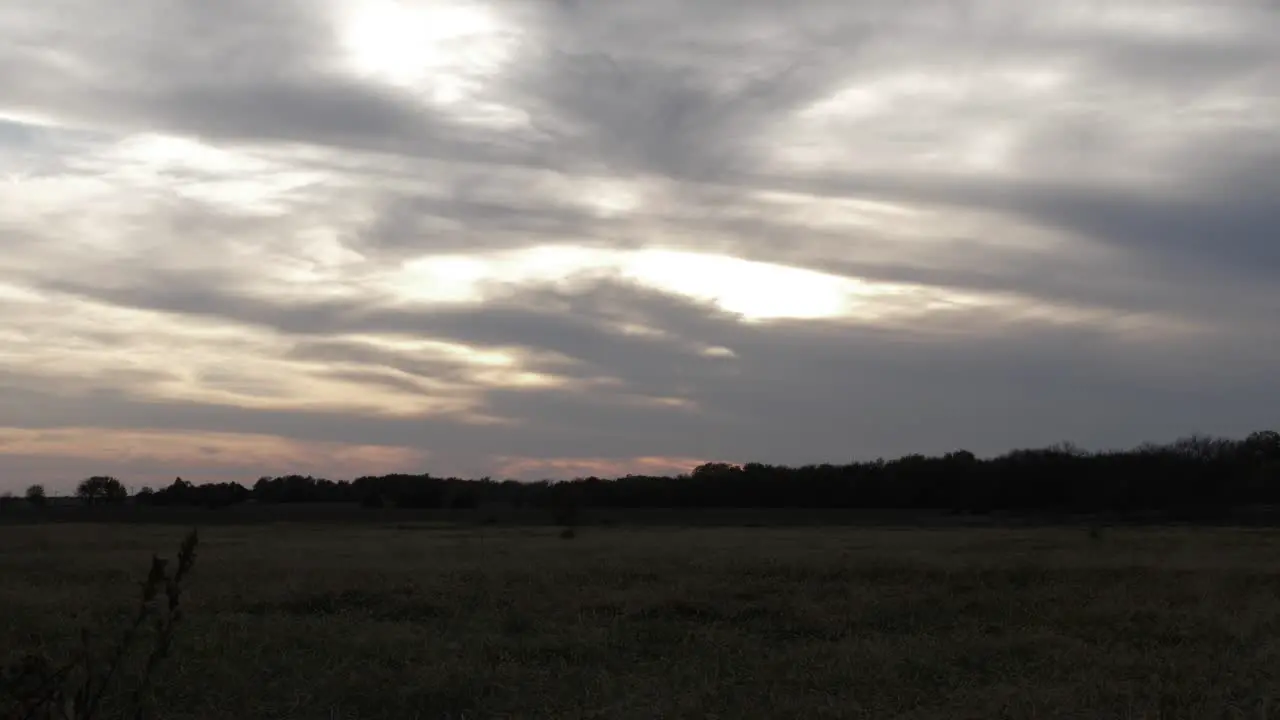 Kansas prairie field during sunset with beautiful clouds in the sky