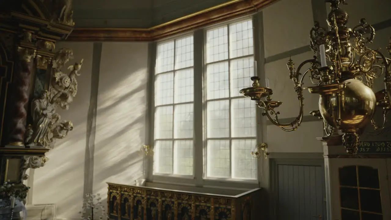 Golden Chandelier hanging in a church with beautyful sunlight