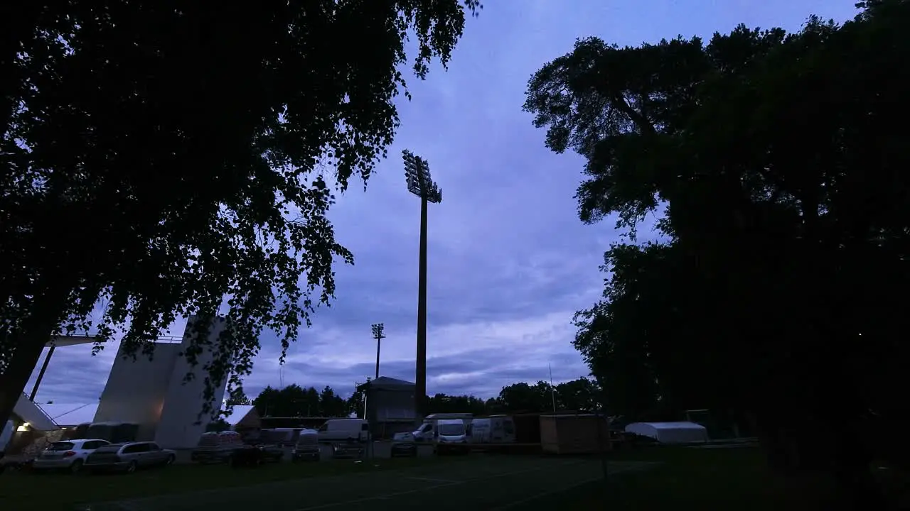 Time lapse of a parking lot with clouds rolling in the sky from evening to night